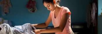 A young woman doing laundry.