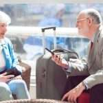 man and woman sitting and talking in an airport