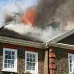 Fire coming through the roof of a house