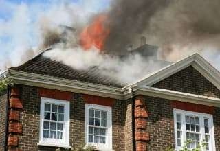 Fire coming through the roof of a house
