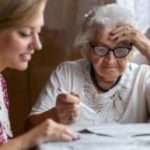 Financial Issues To Consider When An Elderly Parent Moves In With You senior and her child discussing finances