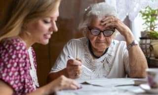 senior and her child discussing finances