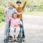 happy wheelchair user with her family